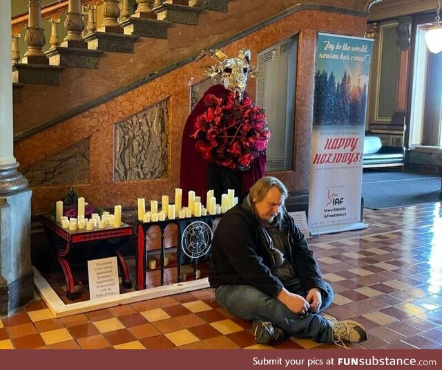 A Baphomet was installed in the Iowa Capitol. A man thinking it represents Satan, pray in