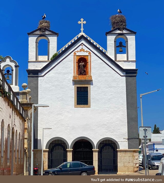 Two storks’ nests on a church in Faro, Portugal