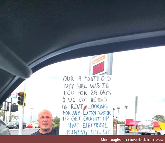 A father holding a sign