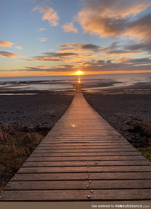 The sun setting over the pier at Seascale Beach, Cumbria