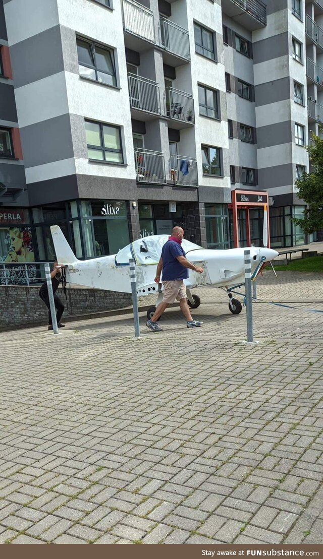 Just a guy pulling his private plane out of an underground parking of an apartment block