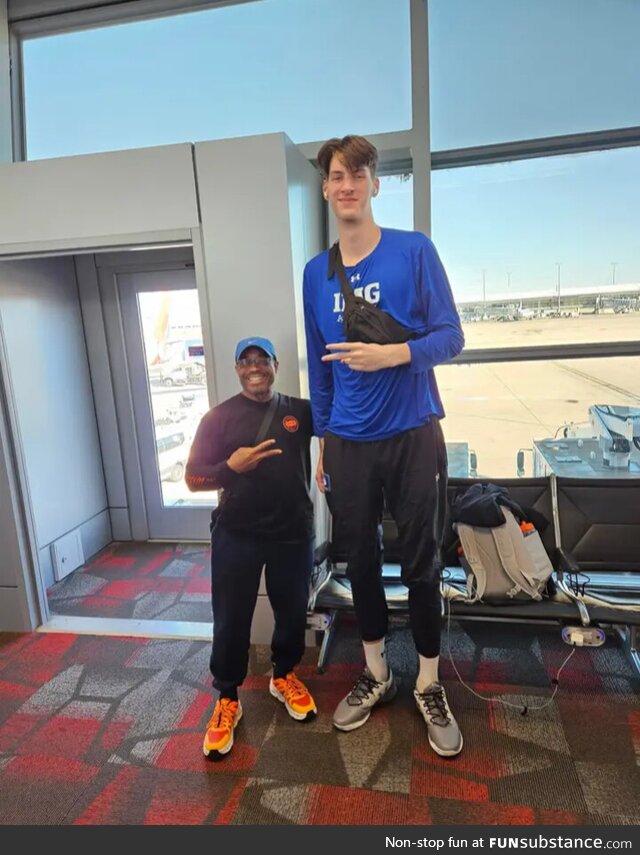 7'8" next to an average size man