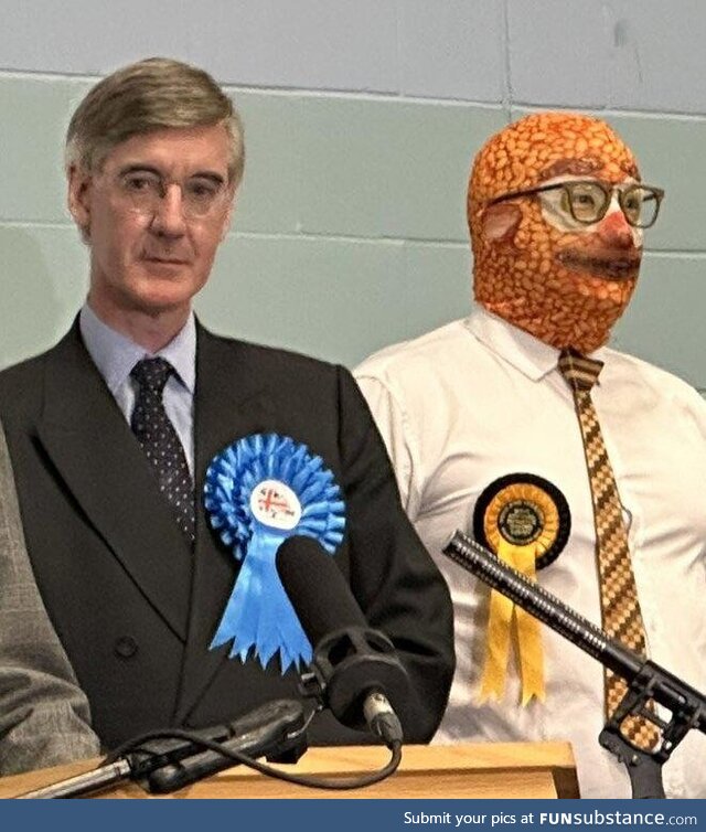 Jacob Rees-Mogg standing next to man wearing a baked beans balaclava after losing the