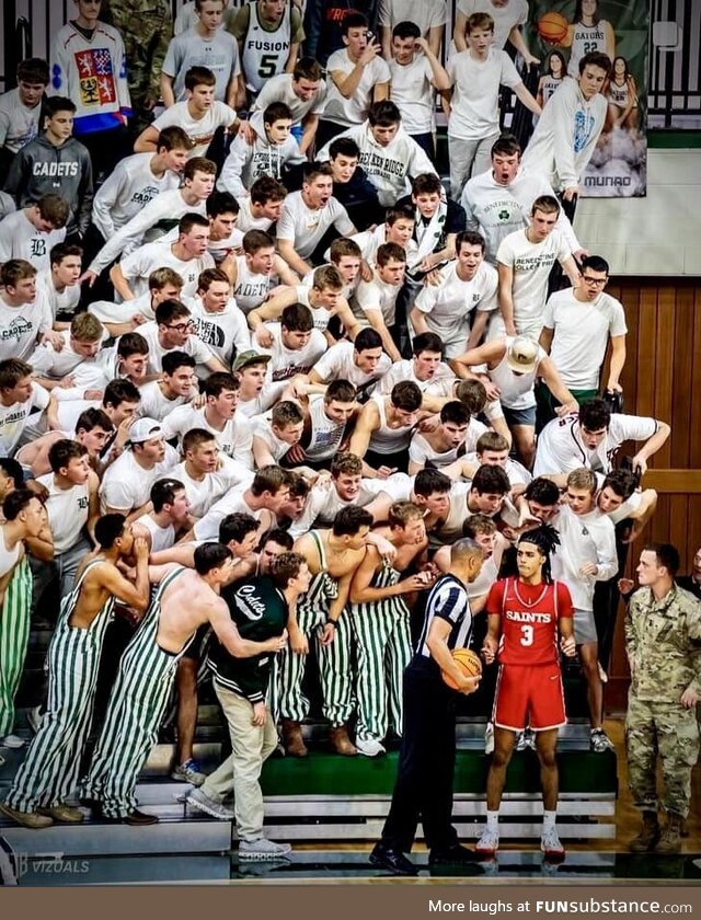 Student fans at a local HS basketball game yelling at an opposing player