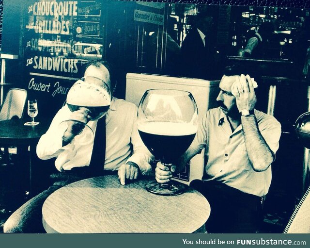 Struggle with finishing a glass of beer. Belgium, 1971