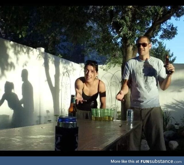 Just two people playing beer pong