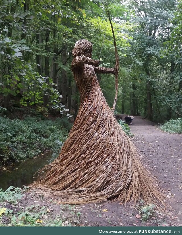 A stunning forest sculpture of a huntress made entirely from willow branches