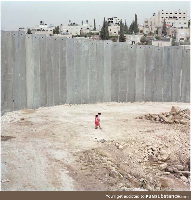 Palestinian kids next to the Separation Wall. Abu Dis, Palestine. 2004