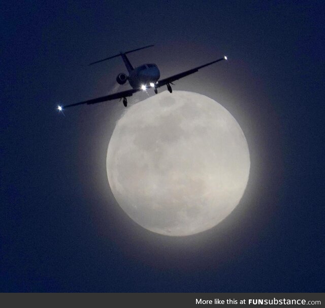 Full Snow Moon with a jet brushing off its top!