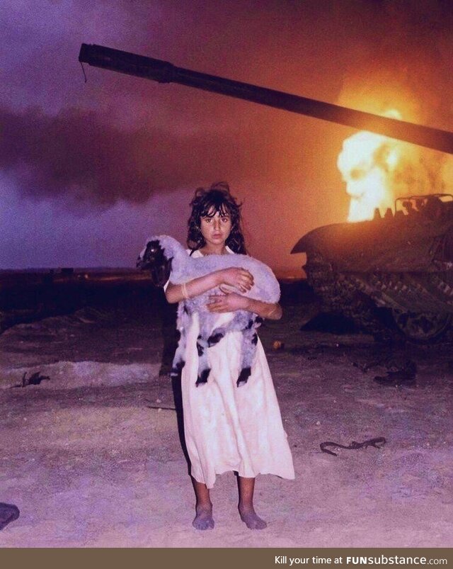 A photo of a young Bedouin Kuwaiti girl holding her lamb, during the Gulf War, (1991)