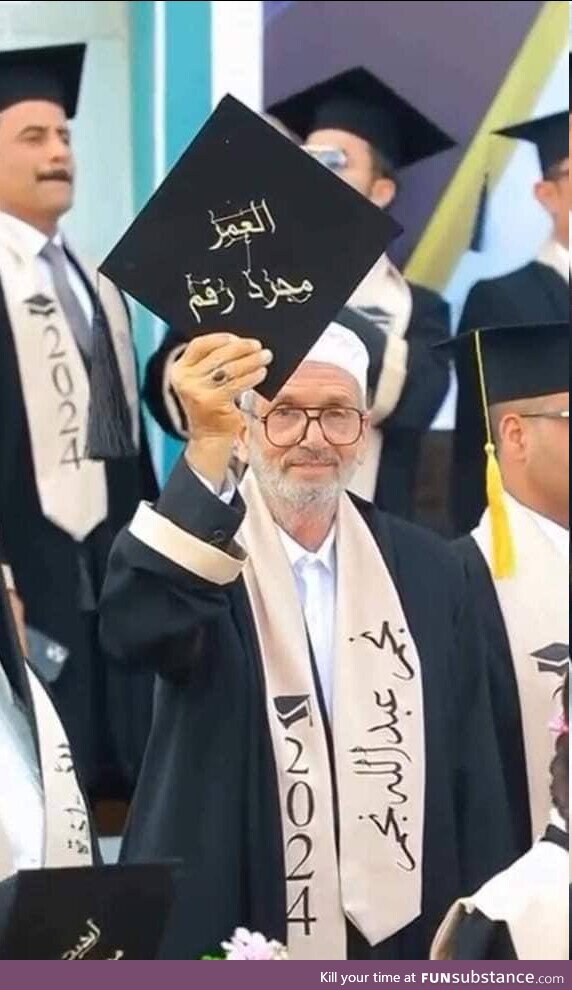 80-years Iraqi man graduating university holding his cap with "Age is Just a Number"