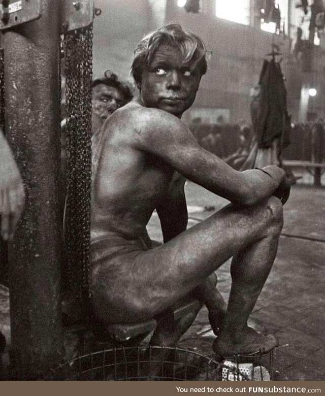 Coal miner waiting to get in the communal shower at the end of a shift, Germany, 1958