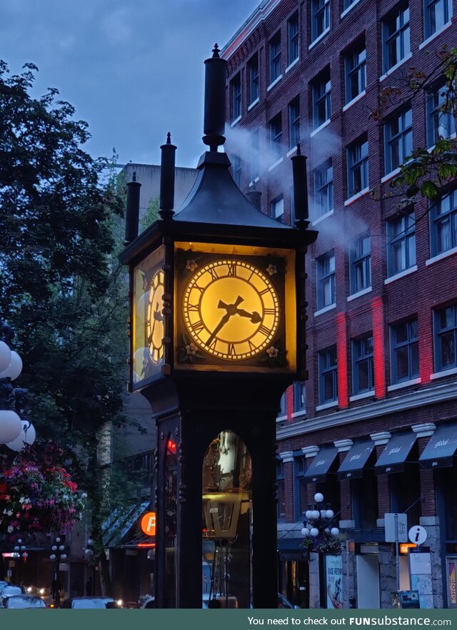 Clock powered by steam engine blowing steam