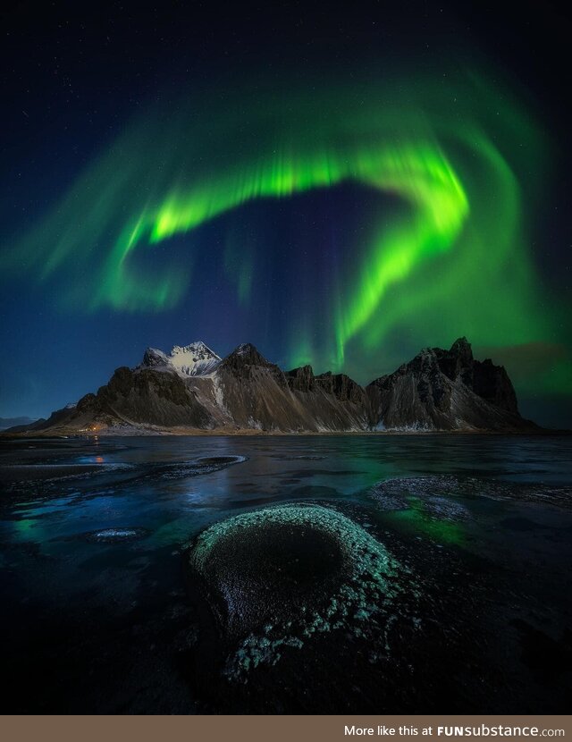 Aurora was intense in East Iceland over a frozen moon lit Arctic beach