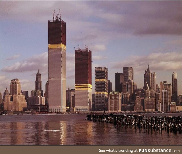 The original World Trade Center under construction, as viewed from Jersey City shoreline