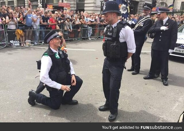 Police officer proposing to his colleague during London pride walk