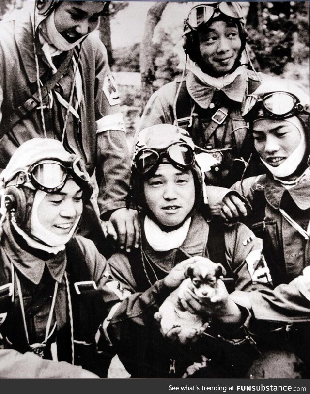 Japanese kamikaze pilots pose with a puppy before their final suicide mission in Okinawa,