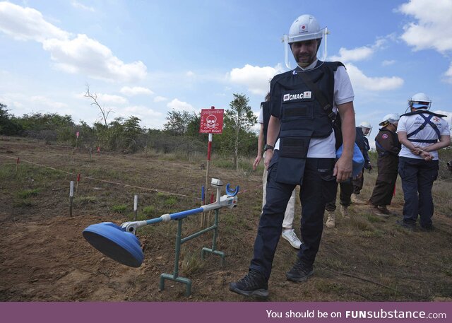 A Ukrainian soldier learning demining techniques from Cambodian experts in Cambodia