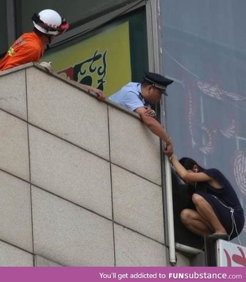 Beijing cop handcuffs himself to suicidal woman on ledge to save her life