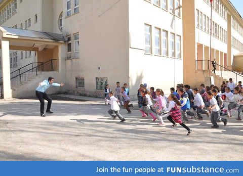 A teacher welcoming his students on the first day of school