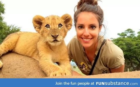 Takes picture with lion cub, manages to be cutest one in the photo