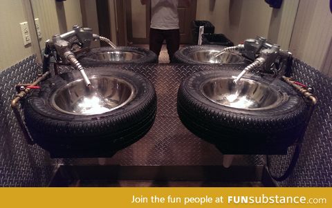 These sinks are tires (and their faucets are gas pumps)