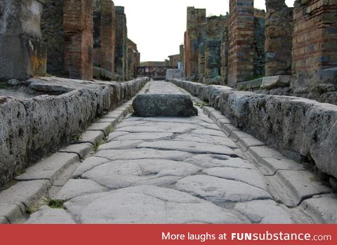 Stone street in Pompeii with tracks for chariot wheels