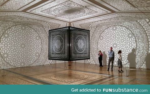 Laser cut wooden cube suspended from the ceiling