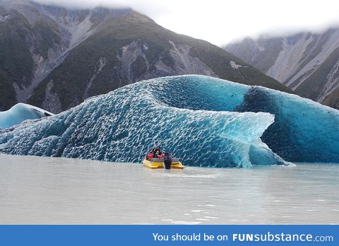 The dark blue bottom of an iceberg that just rolled over