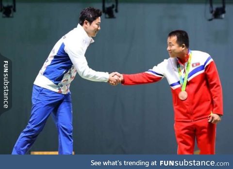 Olympic shooters from both Koreas shakes hands during the medal ceremony