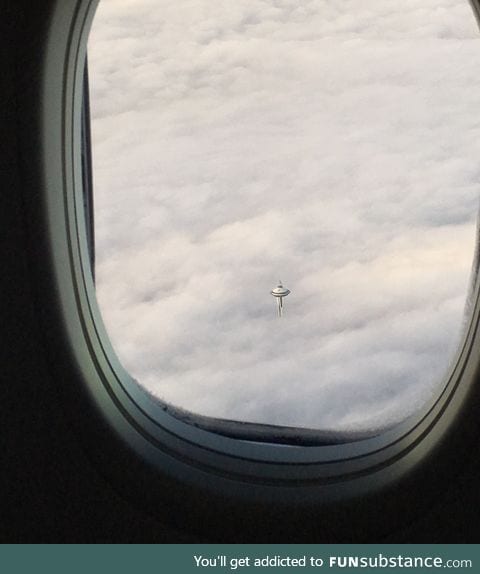 Space Needle in Seattle over clouds looks like the cloud city from Star Wars