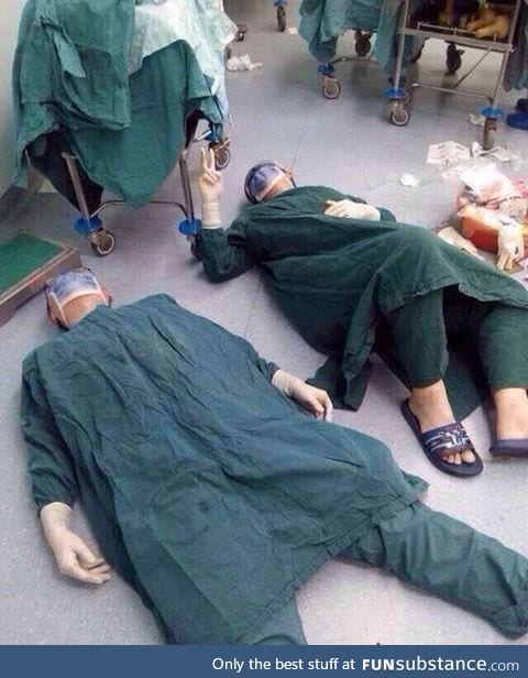 2 surgeons after successfully removing a set of brain tumors during a 32 hour surgery