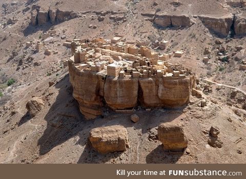 A village in Yemen basically built on top of a huge rock