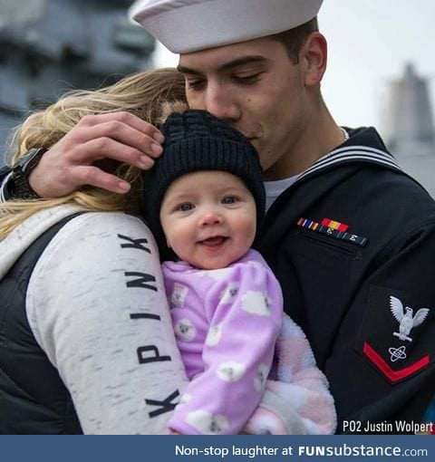 Ridiculously photogenic baby meets her dad for the first time