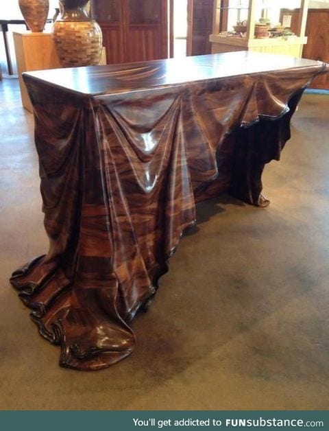 Wooden table with wooden cloth carving