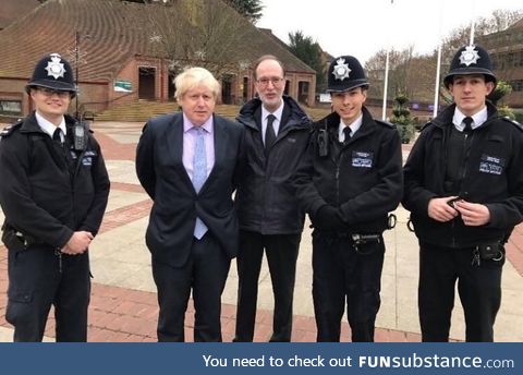 Don’t hold your hands behind your back while taking a photo with police officers