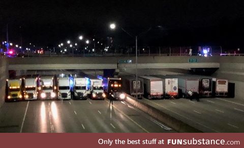 Truckers trying to keep a man from jumping