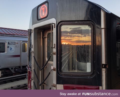 Sunset reflected by a 7 train