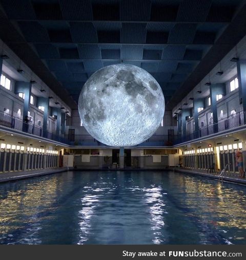 The art installation “Museum of the Moon” at a swimming pool in Italy