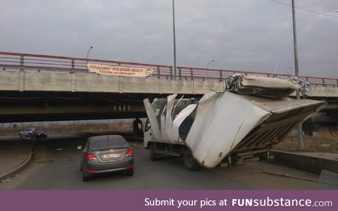 In St. Petersburg there is a bridge with banner "Low bridge, a truck will not