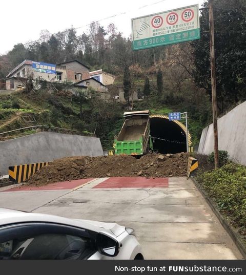 Wuhan, China city officials use dirt to block roads