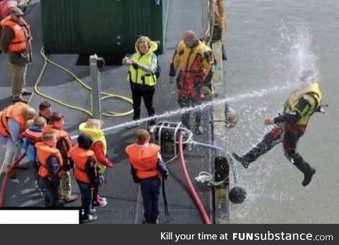 Kids playing with water hose during Coast Guard demonstration