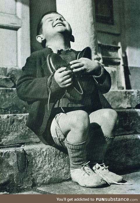 A 6 year-old boy, living in an orphanage in Austria rejoices and hugs a new pair of shoes