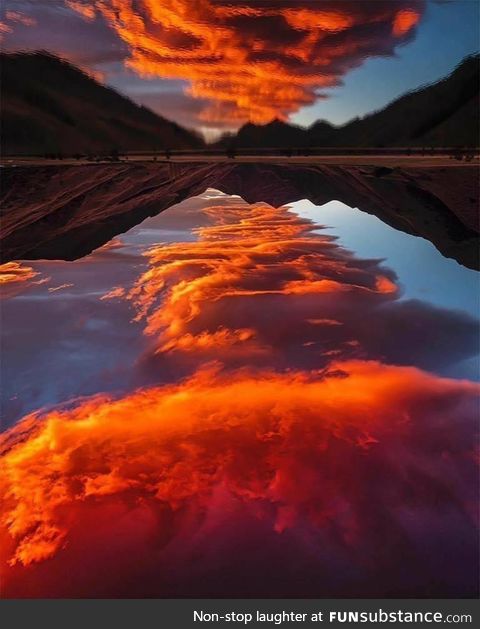 Lake reflects the red clouds