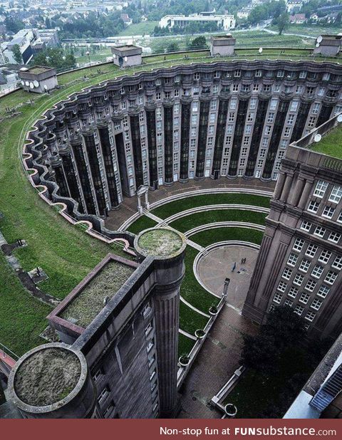 The curved building is Le Théâtre at the Espaces d’Abraxas, a real estate complex