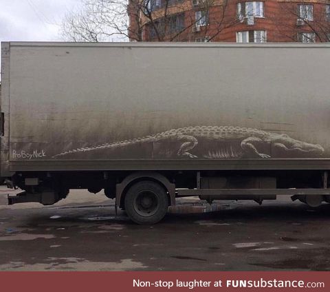 Alligator drawn into dirt on side of a truck