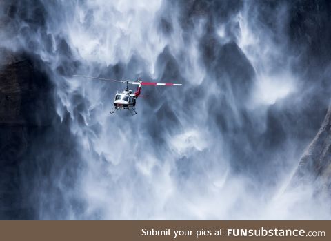 A helicopter near Yosemite waterfall, USA