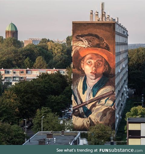 A huge mural on the side of a flat