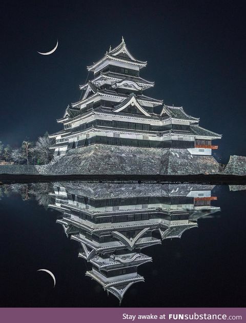 Matsumoto Castle looking like an evil fortress reflecting off the water