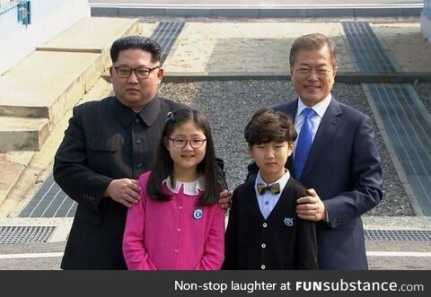 Korean gay couple celebrates their marriage with a family photo, circa. 2017